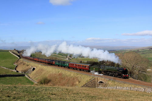 A steam train passes by on the Settle and Carlisle line near Kirby Stephen